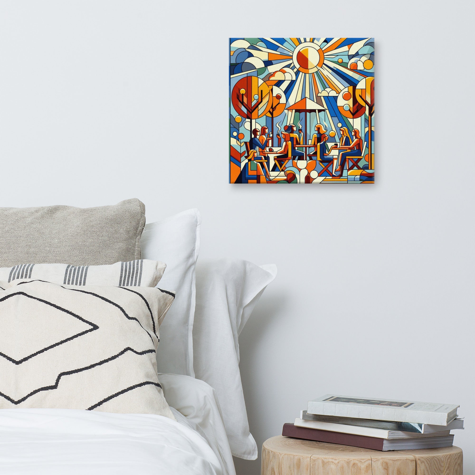 Sunlit cafe terrace abstract painting on a wall above a bed with pillows and books.