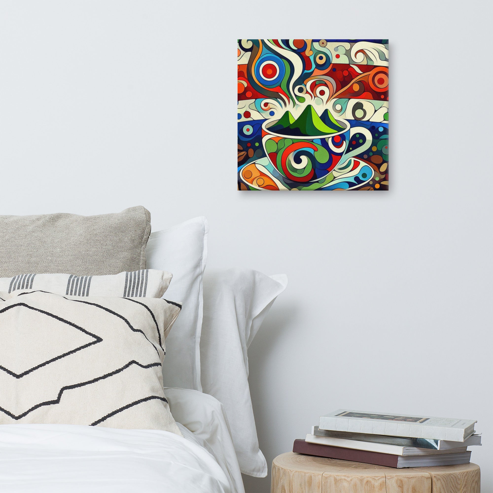 Colourful abstract painting of a coffee cup on a wall above a bed with pillows and books.